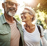 a mature couple smiling with dental implants 